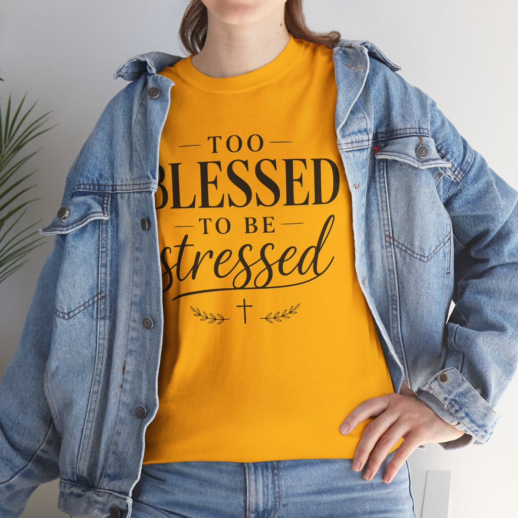 Person wearing a yellow t-shirt with text and a denim jacket indoors.