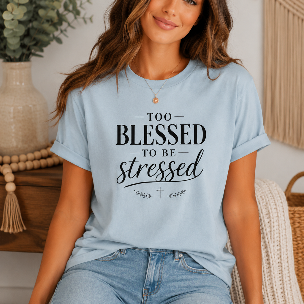 Woman wearing a light blue t-shirt with 'Too Blessed to be Stressed' text in a home setting.